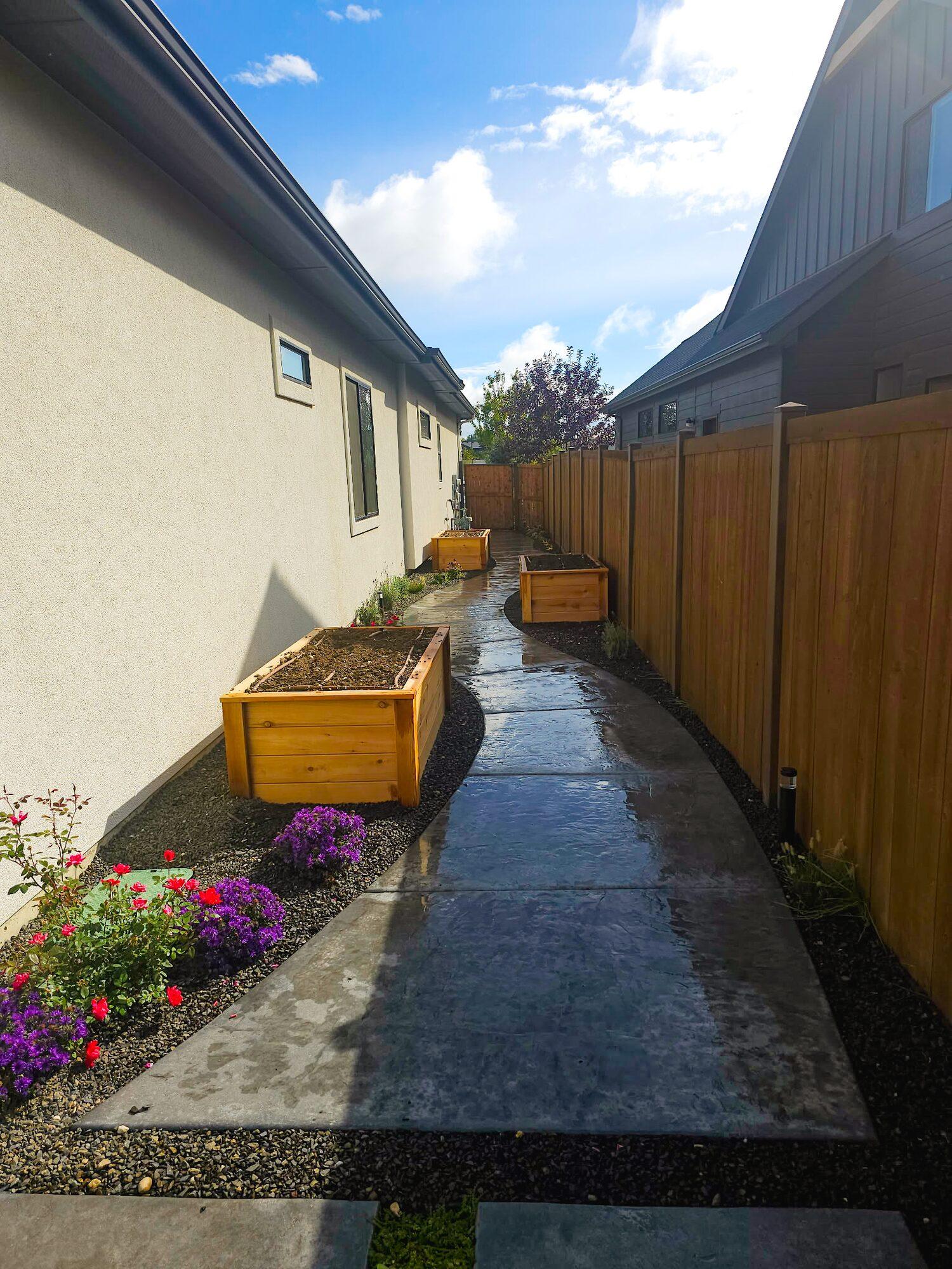 Stamped concrete side yard with garden boxes
