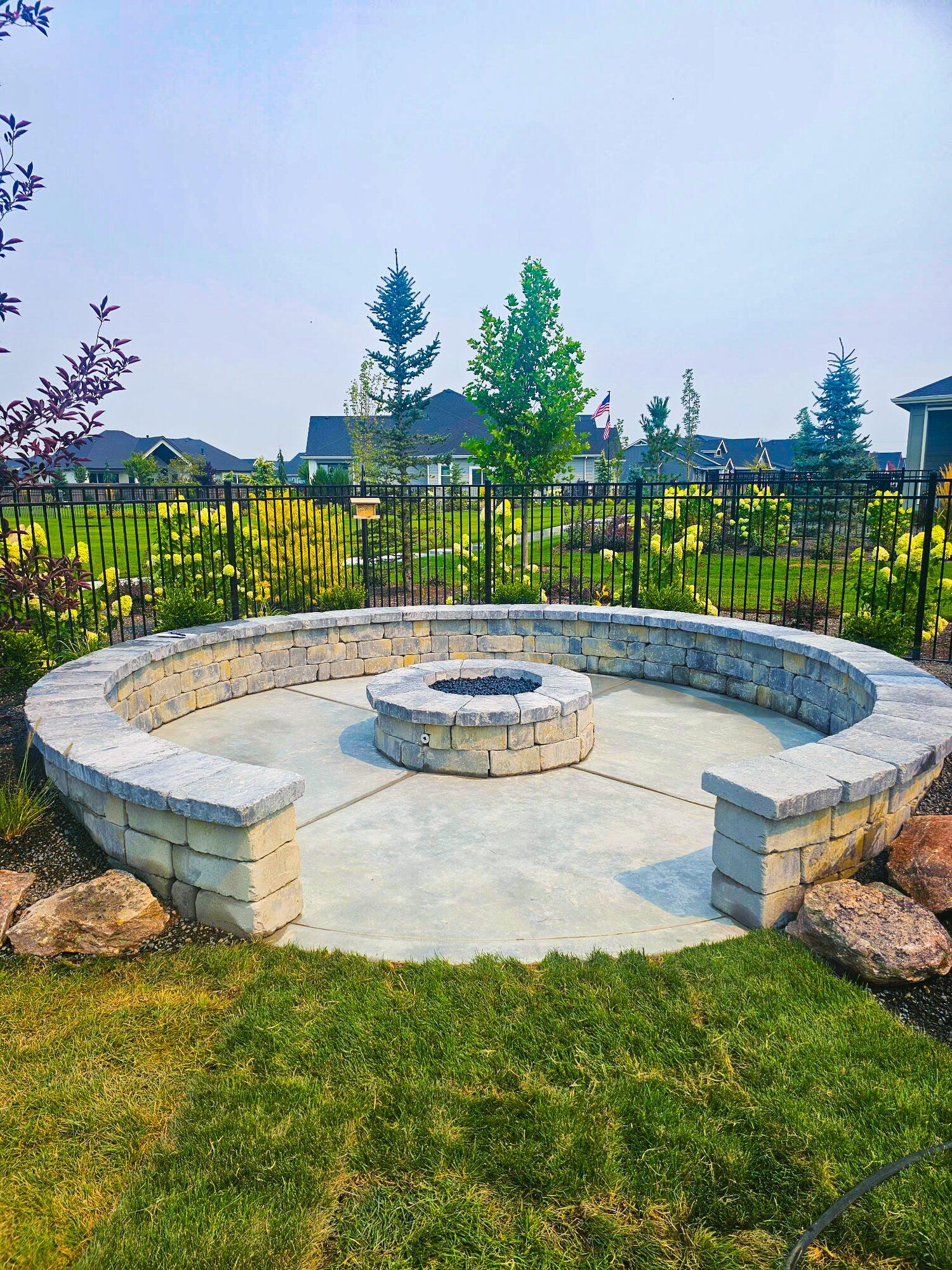 Fire pit beside a decorative wall